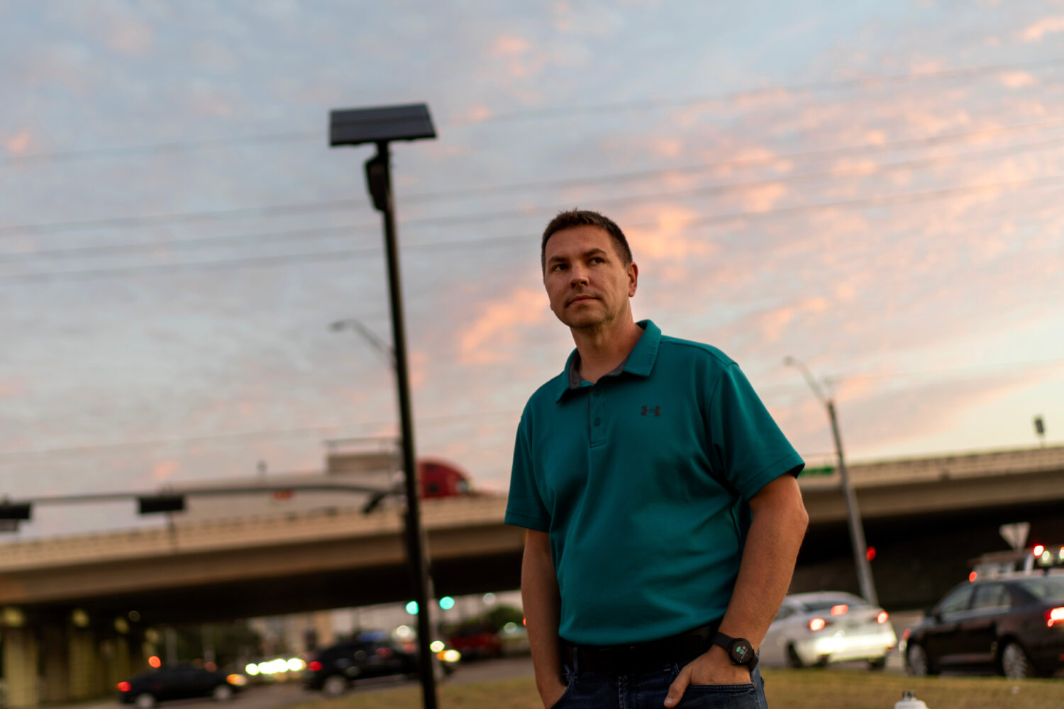 Alek Schott stands next to a Flock Safety license plate reader in his neighborhood, Thursday, Oct. ...