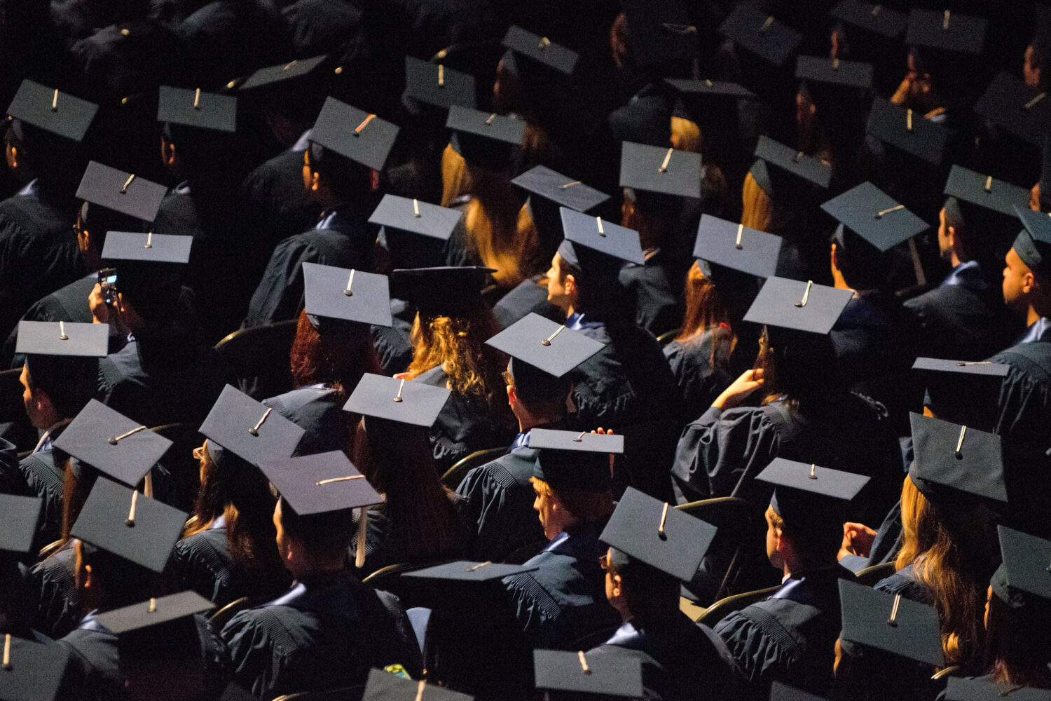 FILE - Students attend commencement ceremonies in the State Farm Center at the University of Illino...