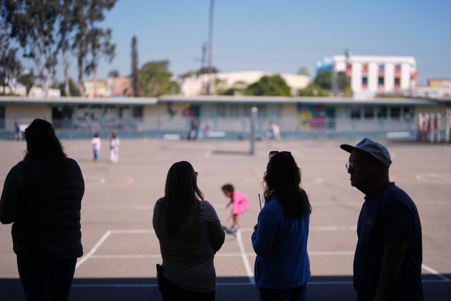Teachers look on as students play on the playground at Perkins K-8 School Thursday, Nov. 13, 2025, ...