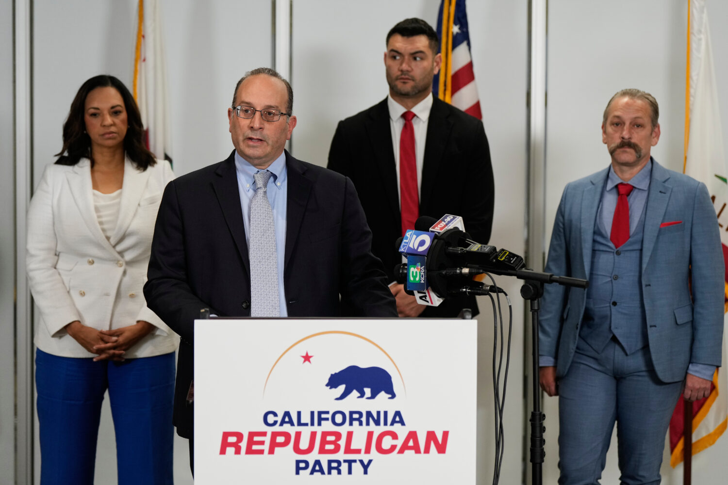 Dhillon Law Group partner Mike Columbo, second from left, speaks to reporters during a press confer...