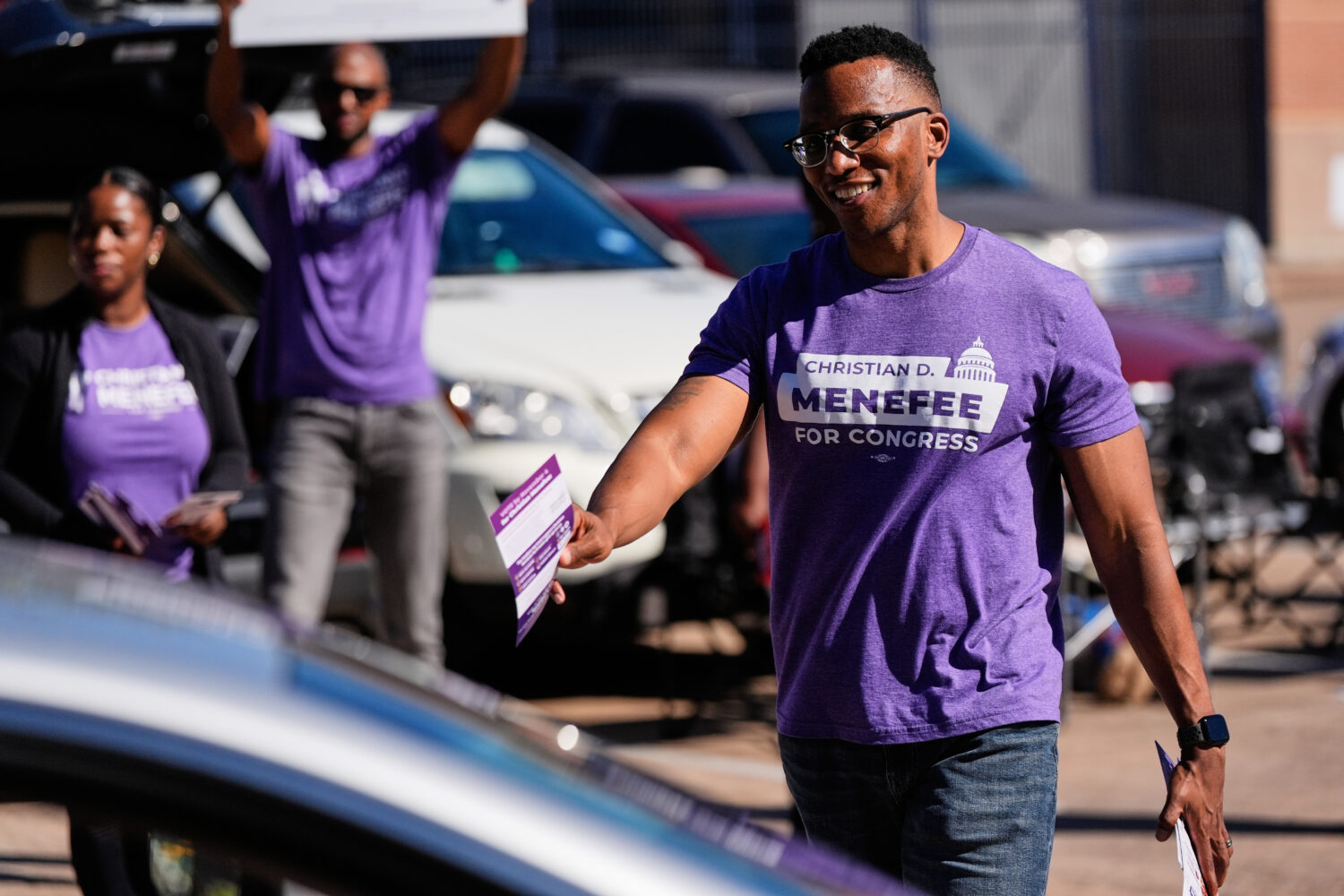 Democratic 18th Congressional District candidate Christian Menefee greets voters near a polling pla...