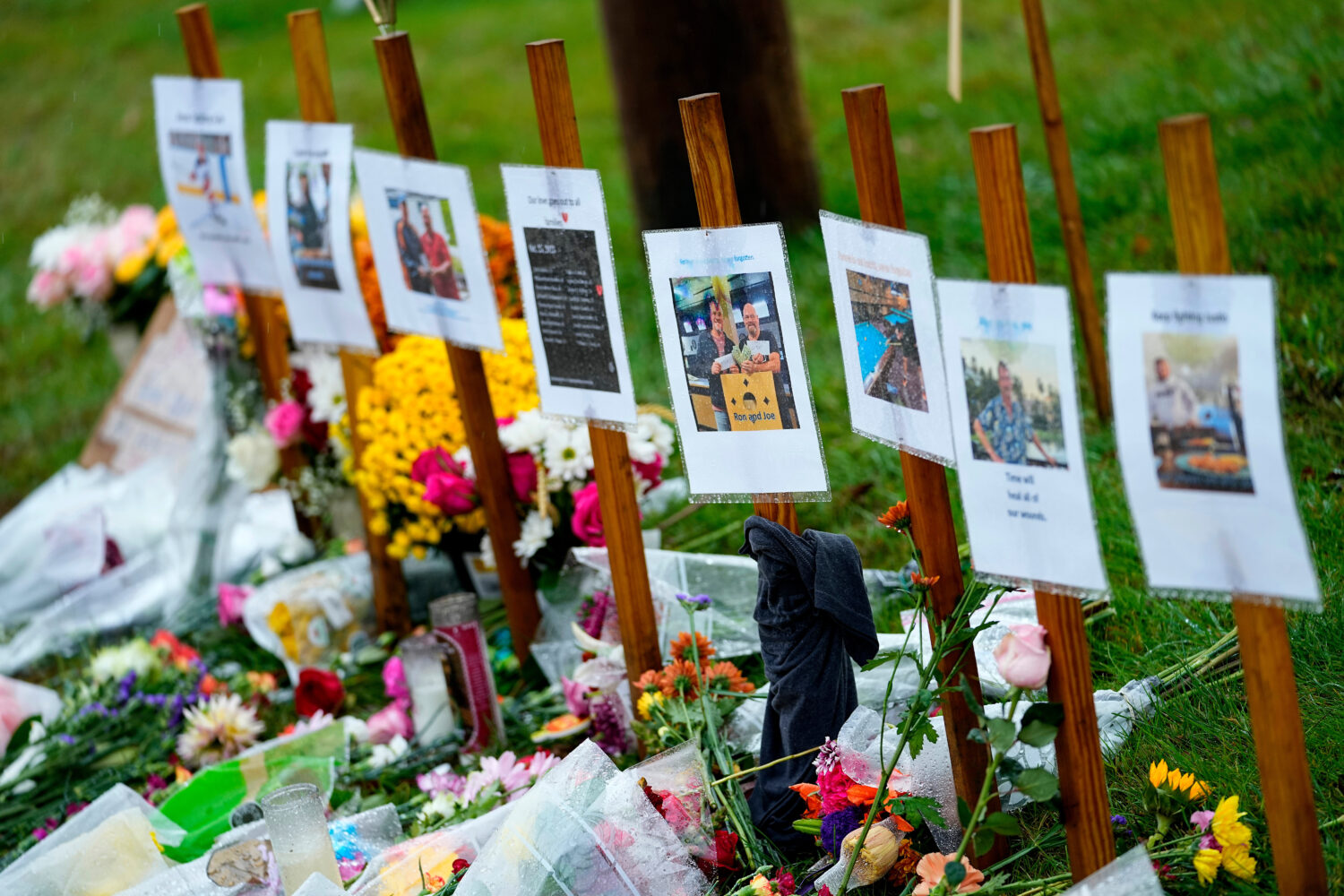 FILE — Rain soaked memorials for those who died in a mass shooting sit along the roadside by Sche...