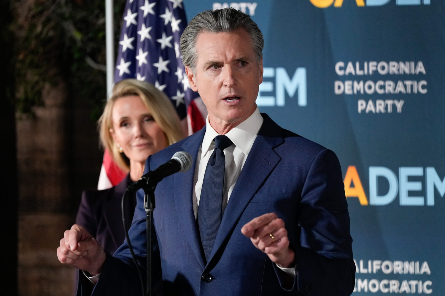 California Gov. Gavin Newsom speaks as he stands with first partner Jennifer Siebel Newsom during a...