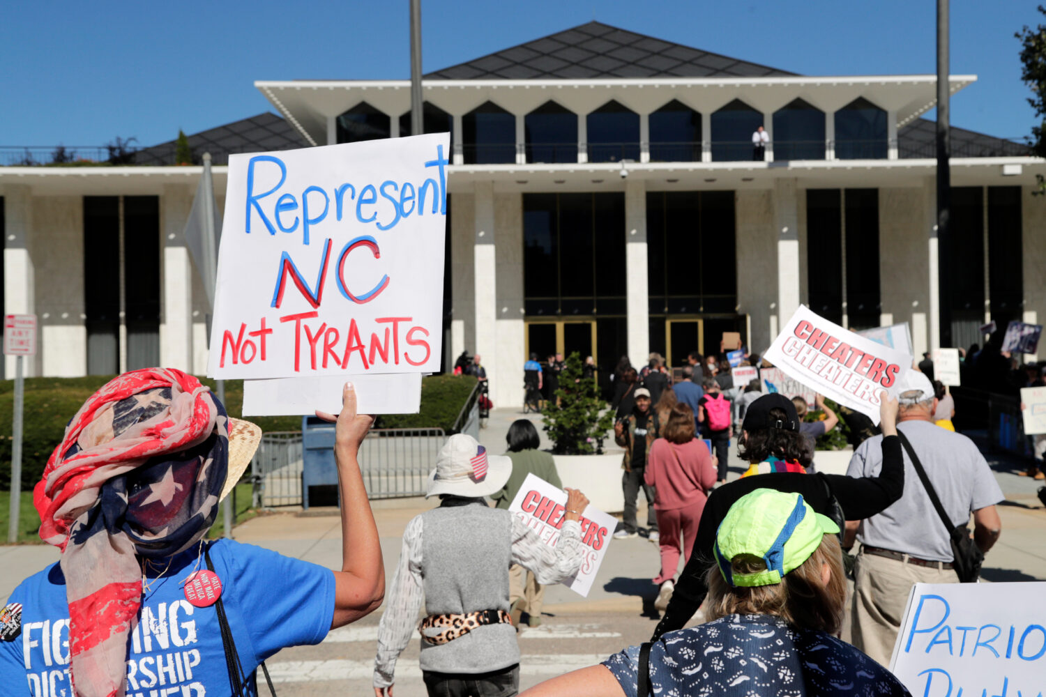 FILE - Demonstrators approach the Legislative Building during a rally protesting a proposed electio...
