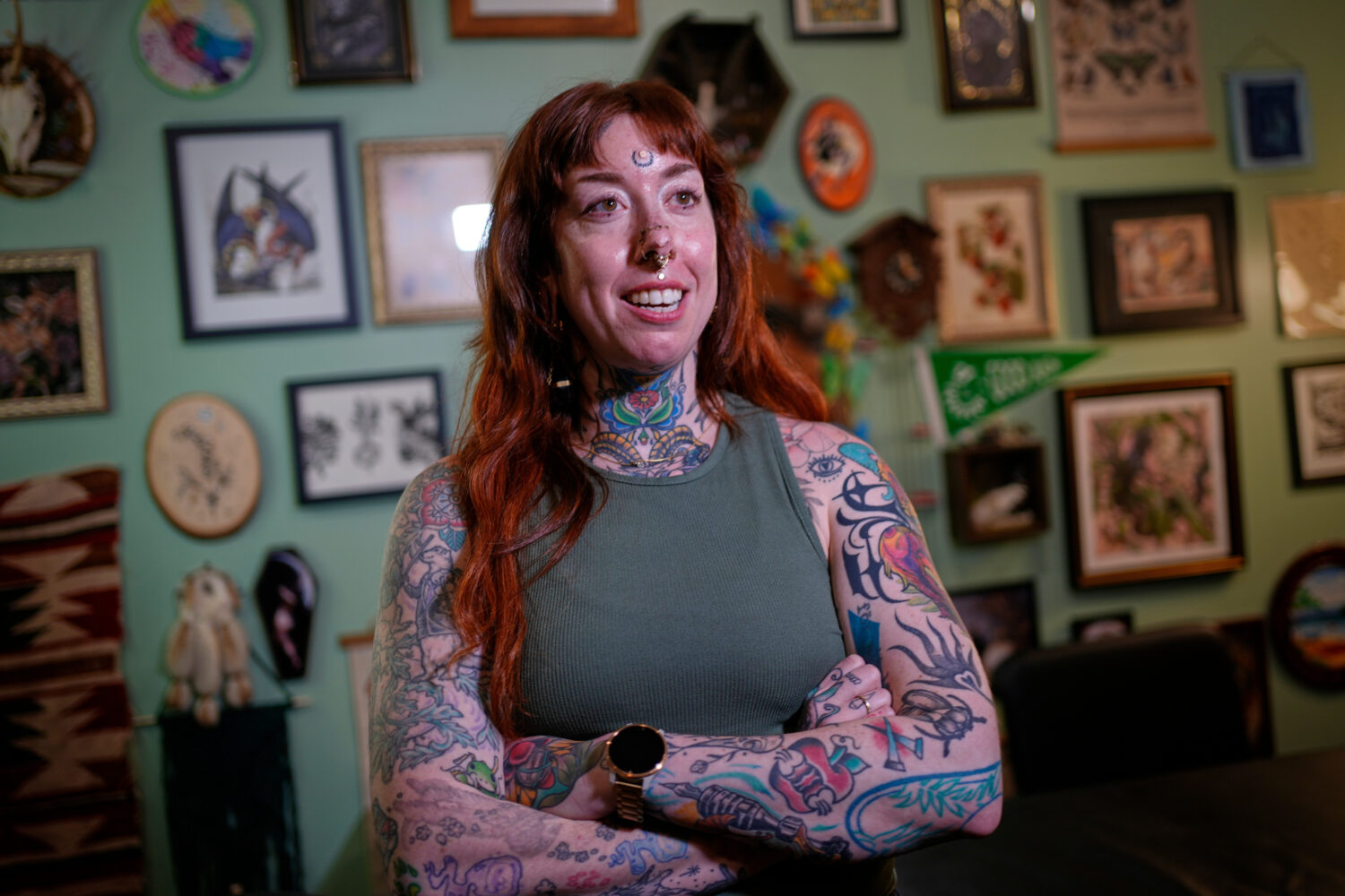 Tattoo artist Mischa Ostberg talks with a visitor at the Ghost Rose Tattoo parlor, Nov. 3, 2025, in...