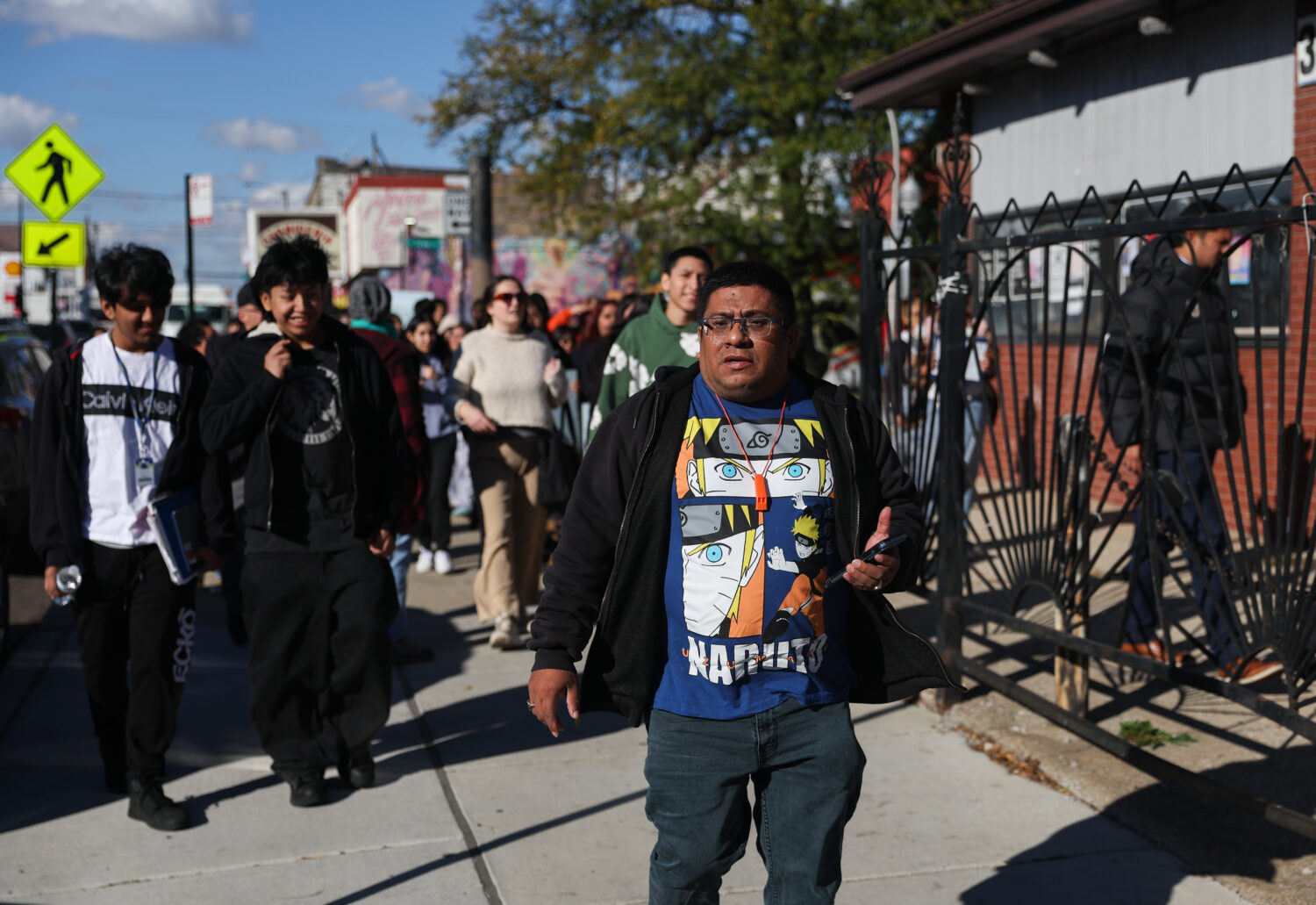 Baltazar Enriquez, president of the Little Village Community Council, walks with a Chicago Public S...
