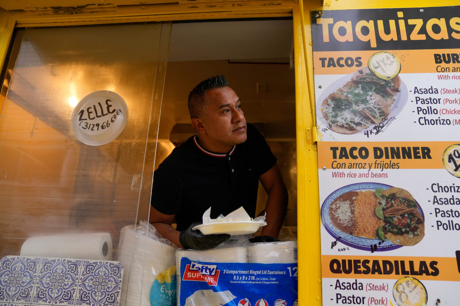 Rafael Hernandez, originally from Mexico, sells food from his family's food truck, Nov. 6, 2025, in...