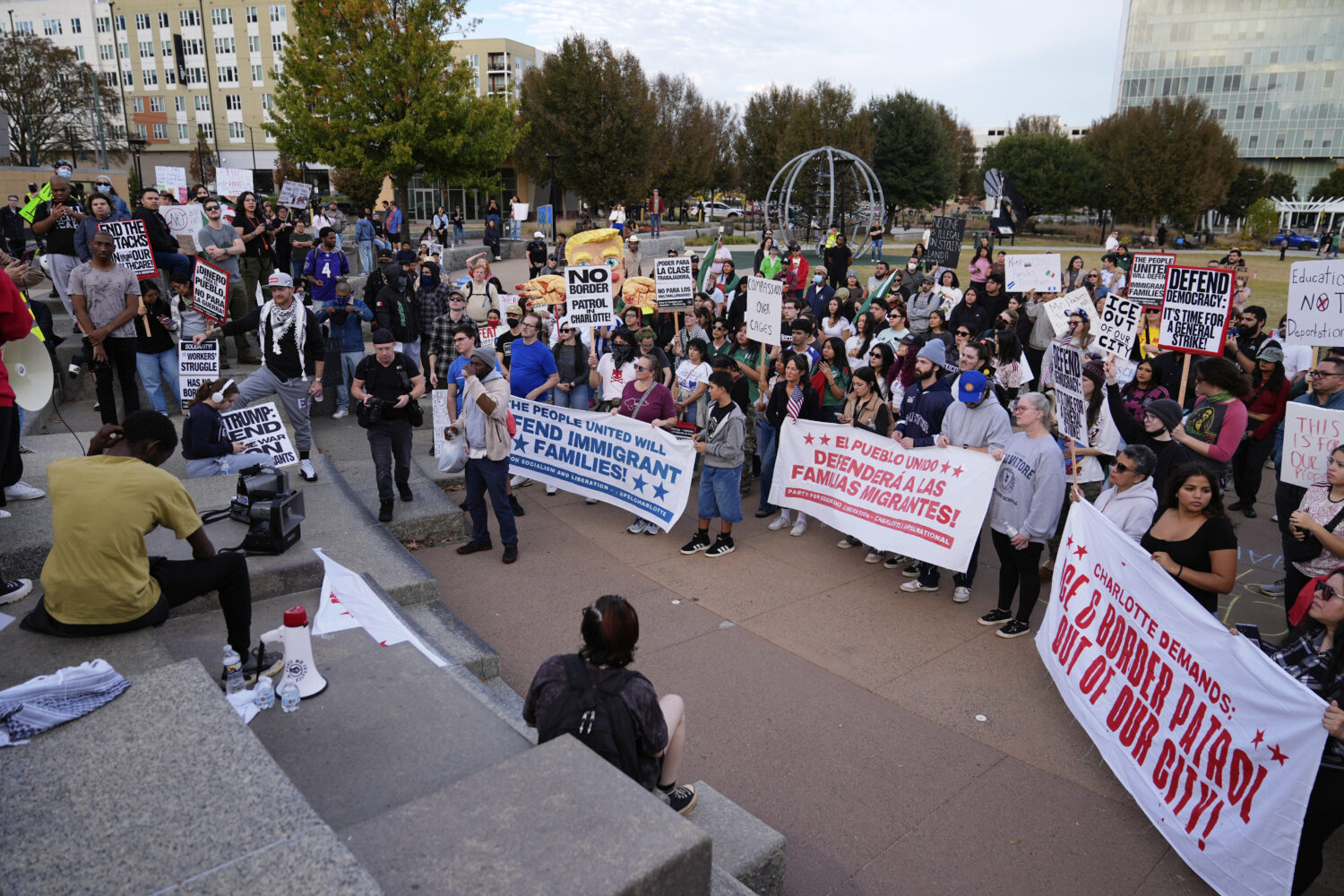 People protest against federal immigration enforcement Saturday, Nov. 15, 2025, in Charlotte, N.C. ...