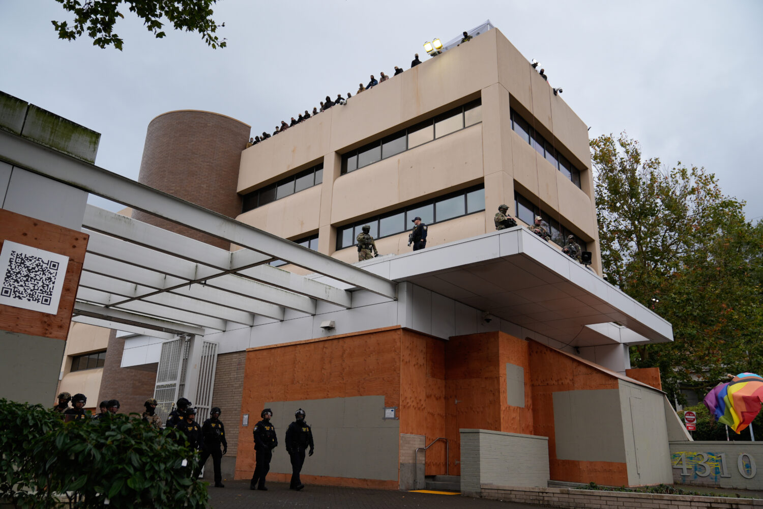 FILE - Law enforcement officers guard a U.S. Immigration and Customs Enforcement facility during a ...