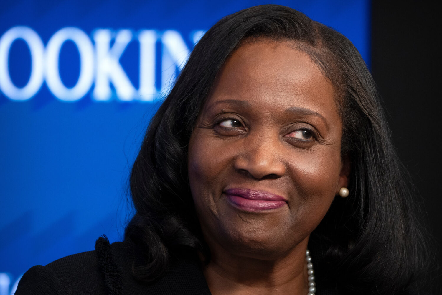 FILE - Lisa Cook, a Federal Reserve Board of Governors member, reacts during an event at the Brooki...