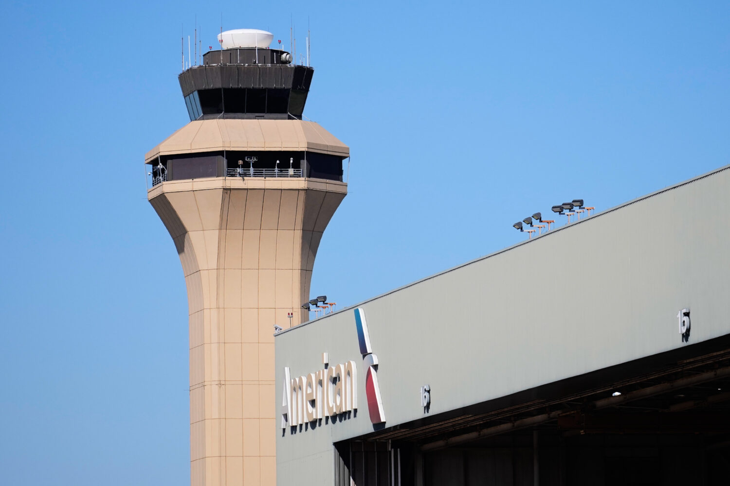 FILE - A control tower by an American Airlines hangar is shown at Dallas Fort Worth International A...