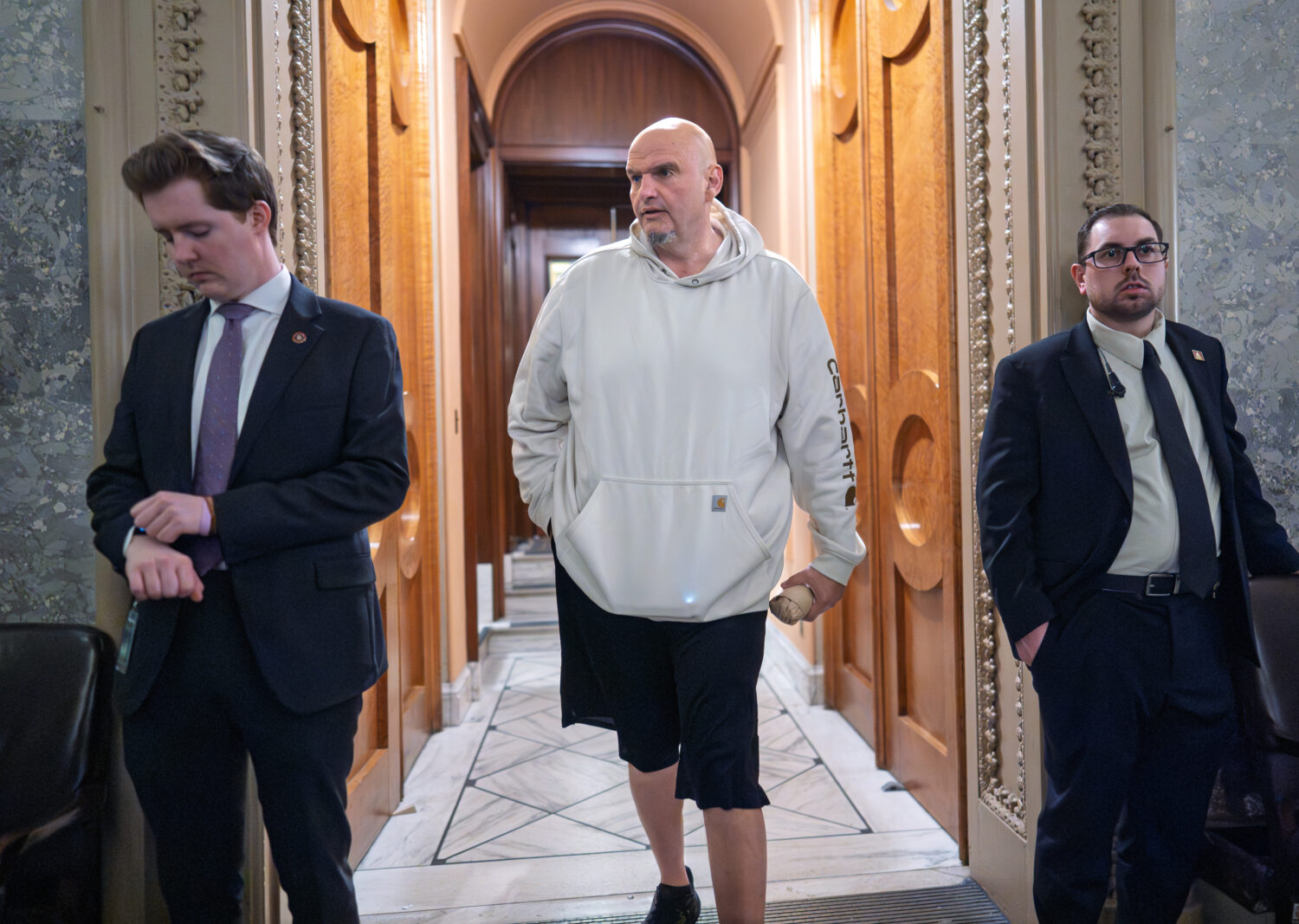 Sen. John Fetterman, D-Pa., a Democrat who has been voting to open the government, leaves the chamb...