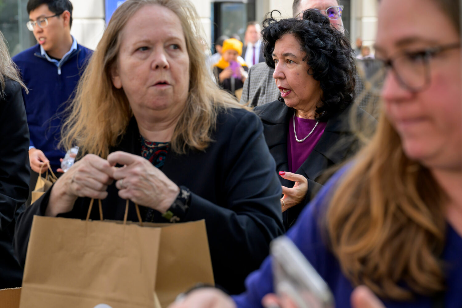 People receive free meals from the World Central Kitchen as they provide food to federal employees ...