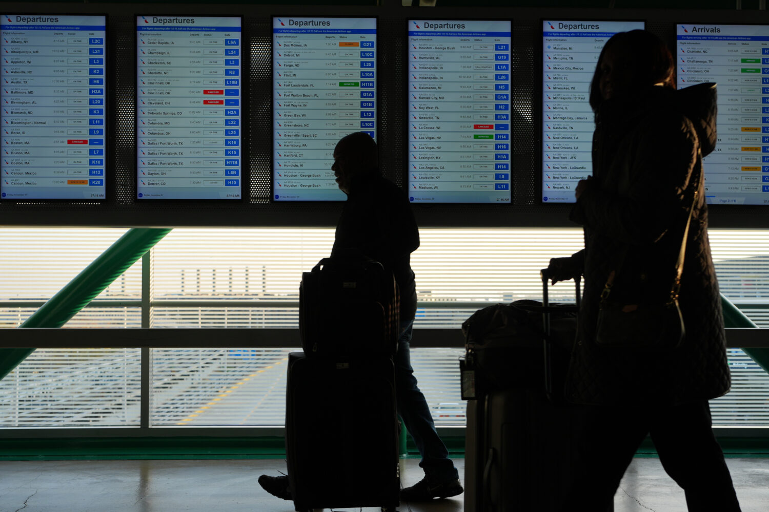 Travelers walk though the terminal at O'Hare International Airport in Chicago, Friday, Nov. 7, 2025...