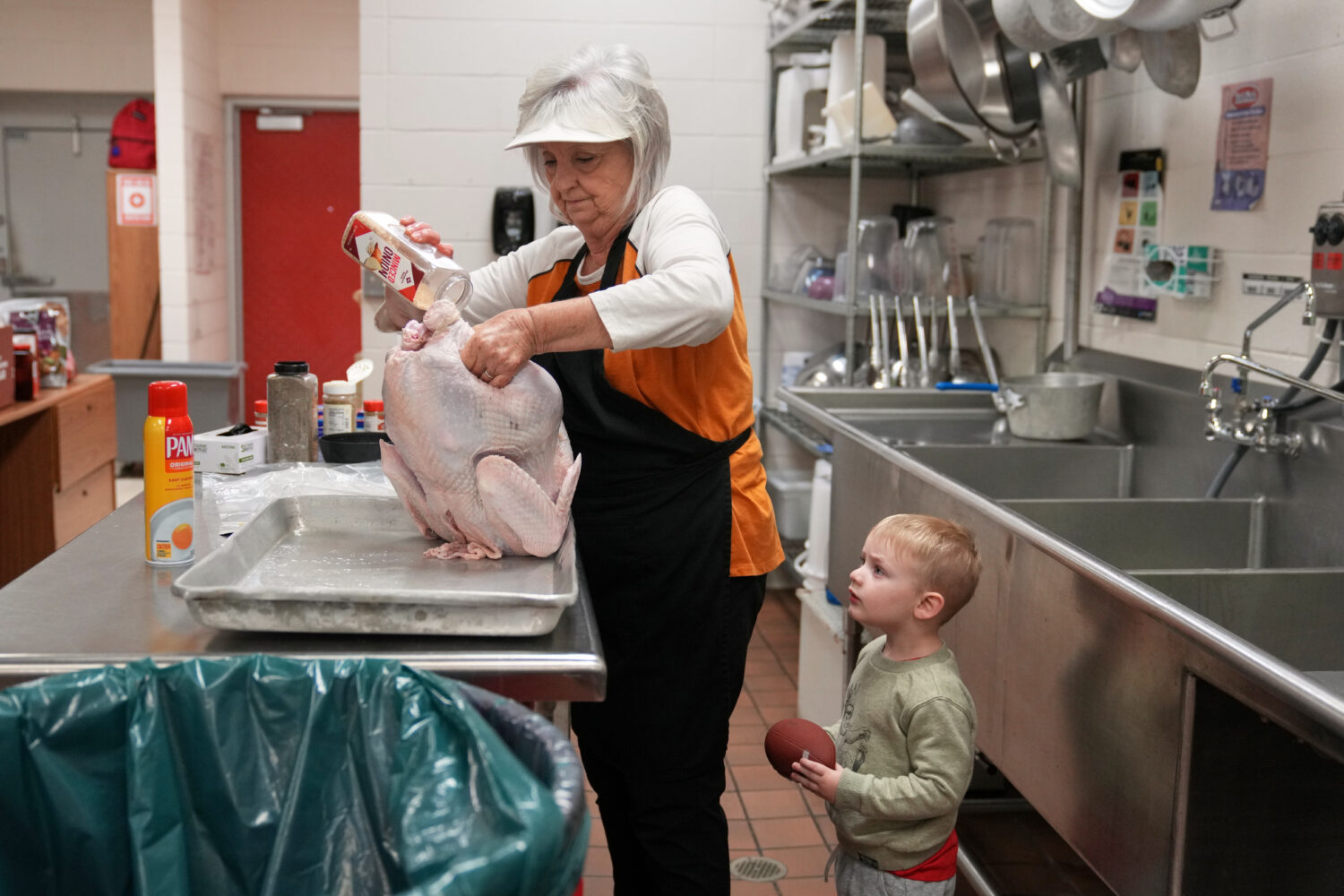 Kooper Keeland, 2, watches as his great-grandmother, high school cafeteria worker Shirley Mease, us...