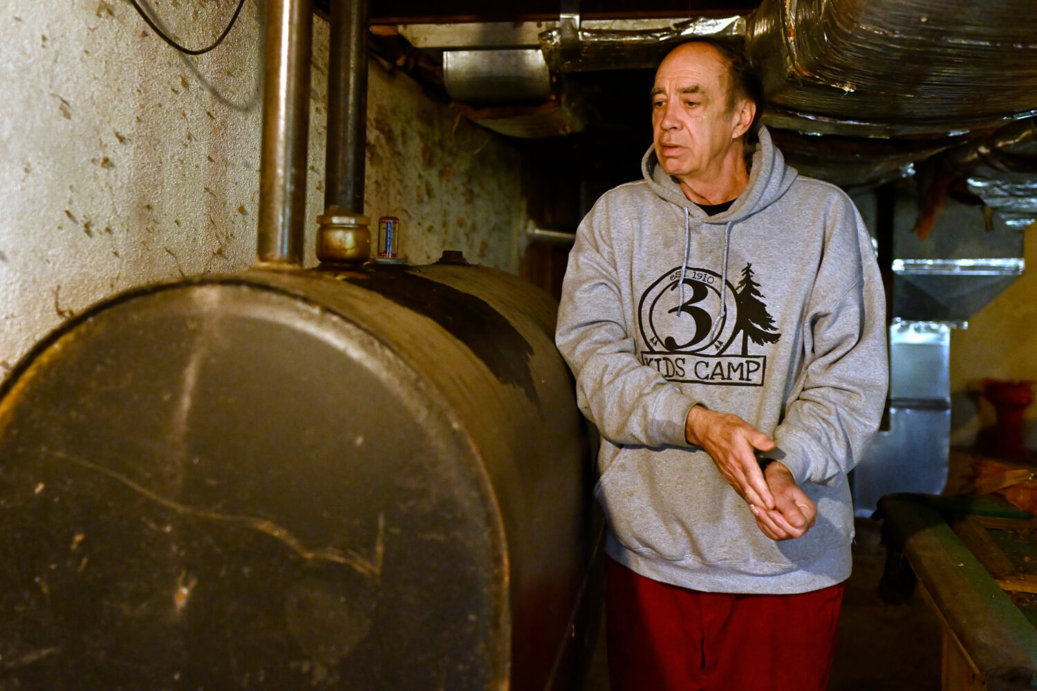 Mark Bain, who is part of the Low Income Home Energy Assistance Program, rubs his hands together as...