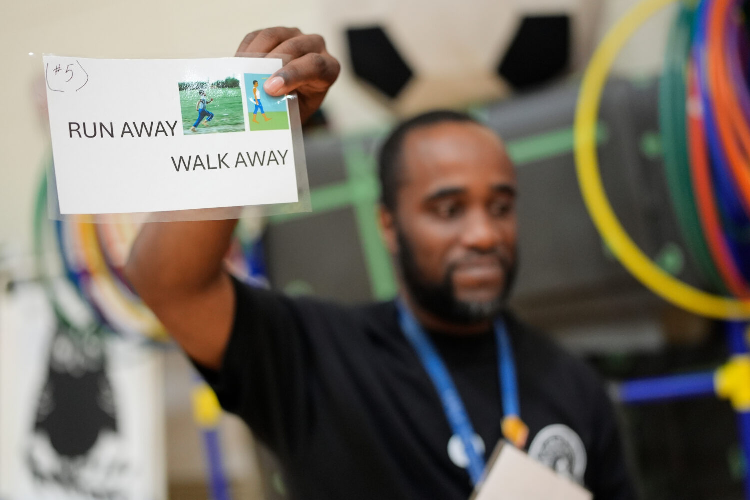 Health and physical education teacher Ronald Anderson holds instructions for students when they enc...