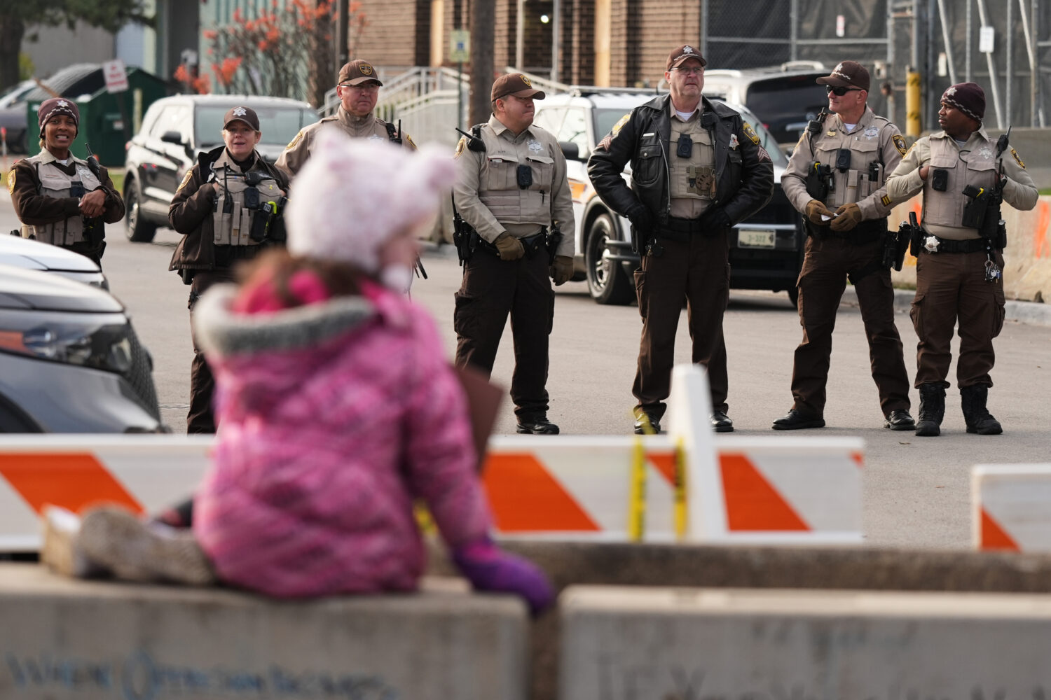 Law enforcement officers guard outside an ICE processing facility in the Chicago suburb of Broadvie...