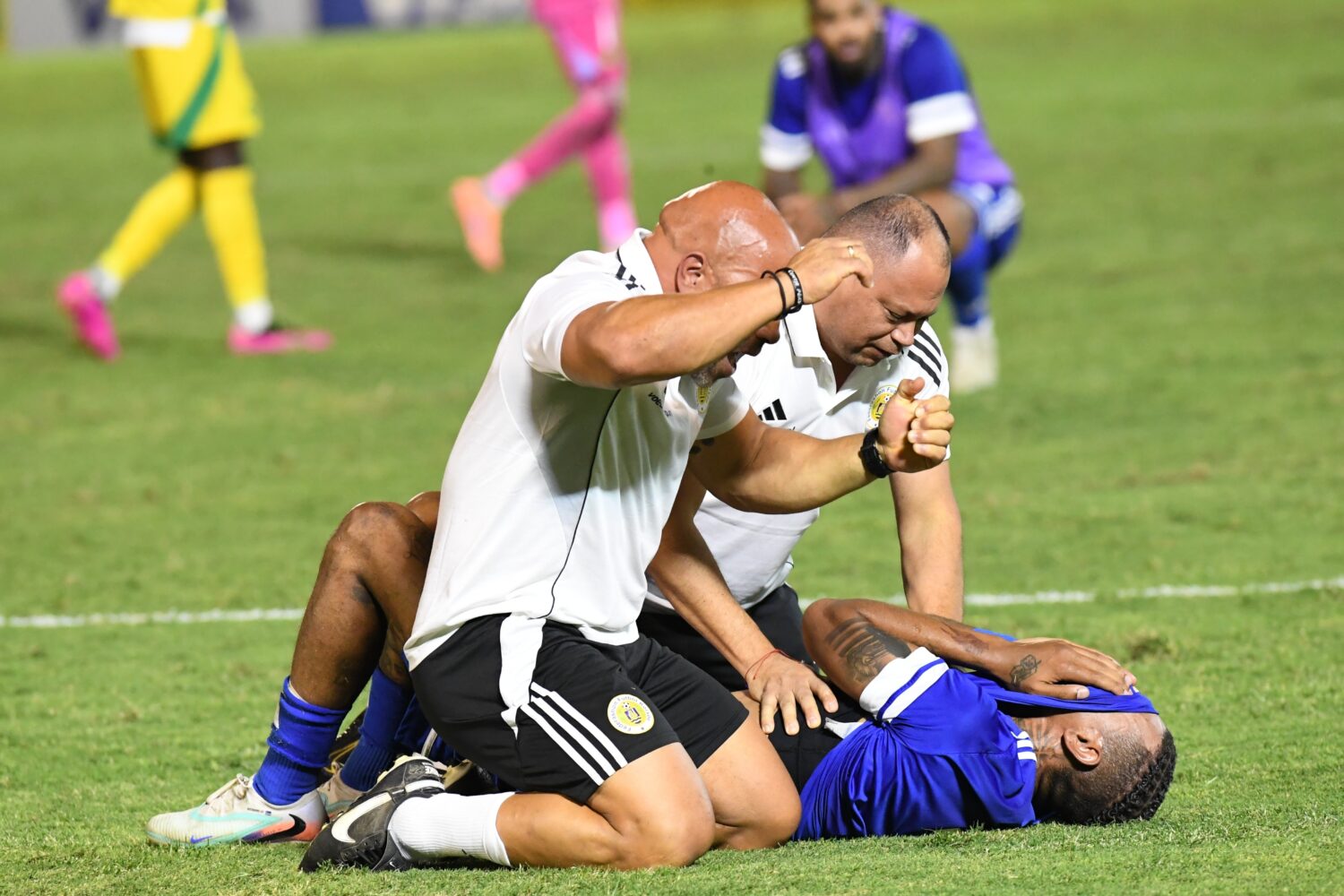 Curacao players and trainers celebrate qualifying for the 2026 FIFA World Cup after their game with...