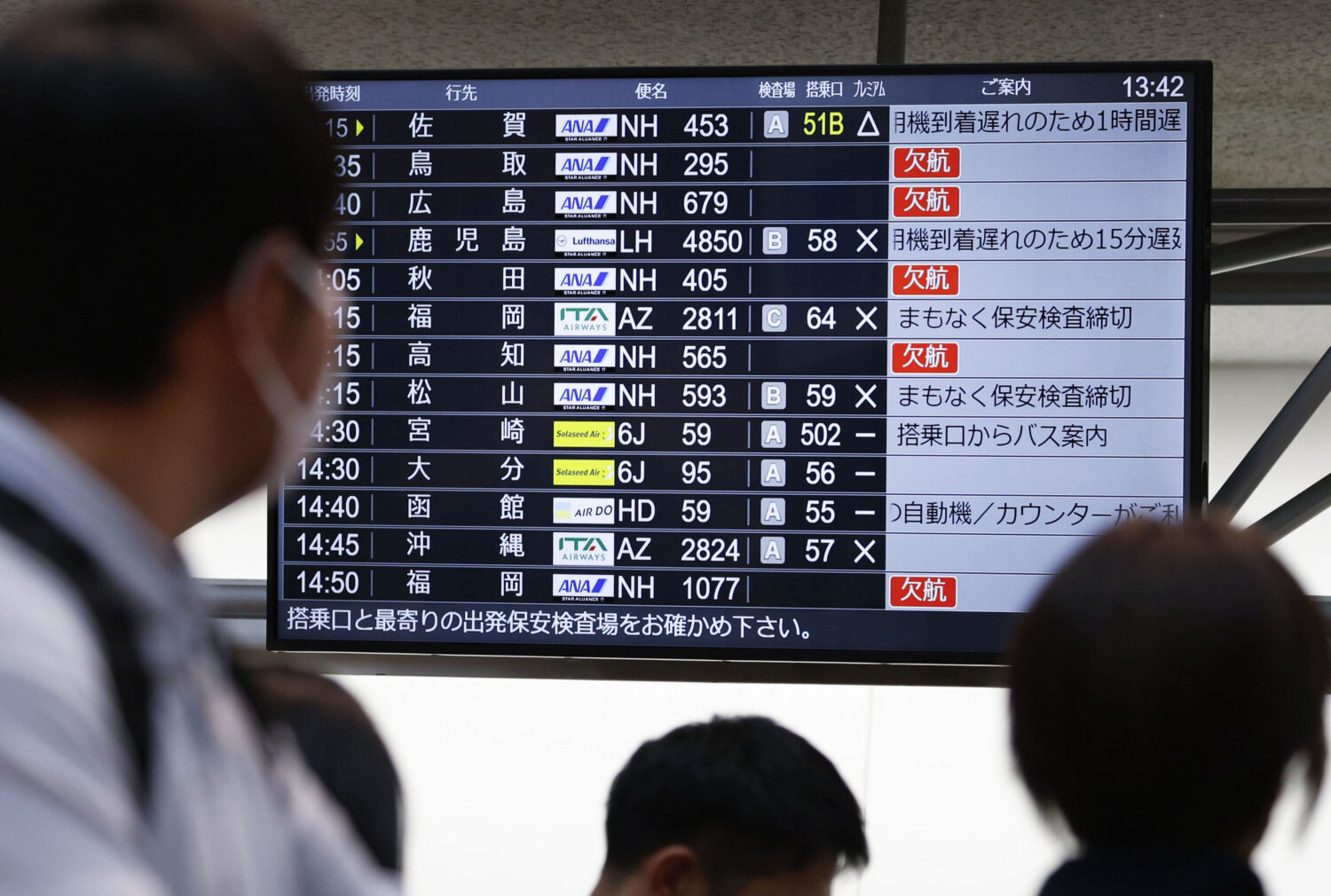 The departures display board shows All Nippon Airways' multipule flights cancellation at Haneda air...
