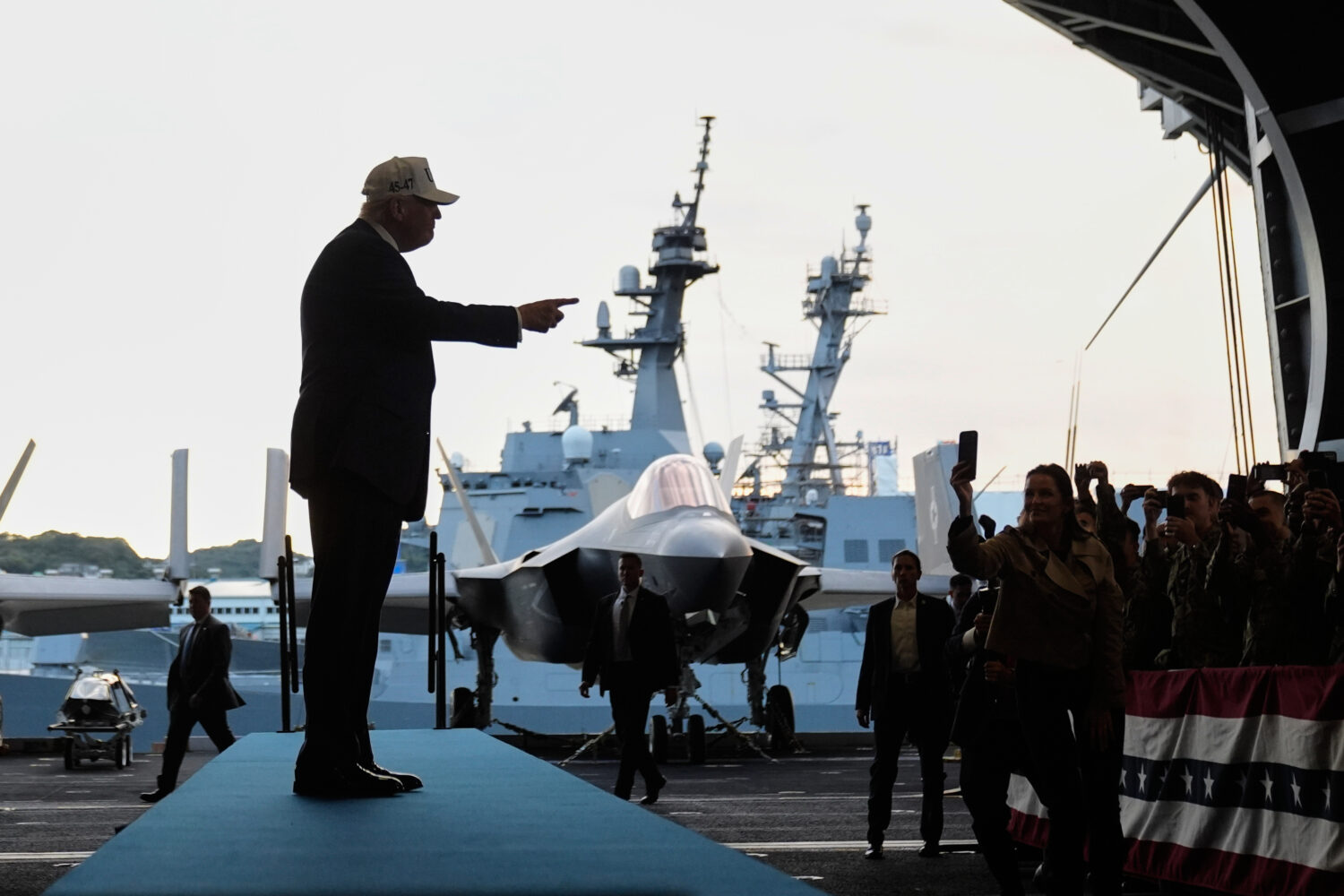 President Donald Trump gestures as he walks towards the stage before speaking to members of the mil...