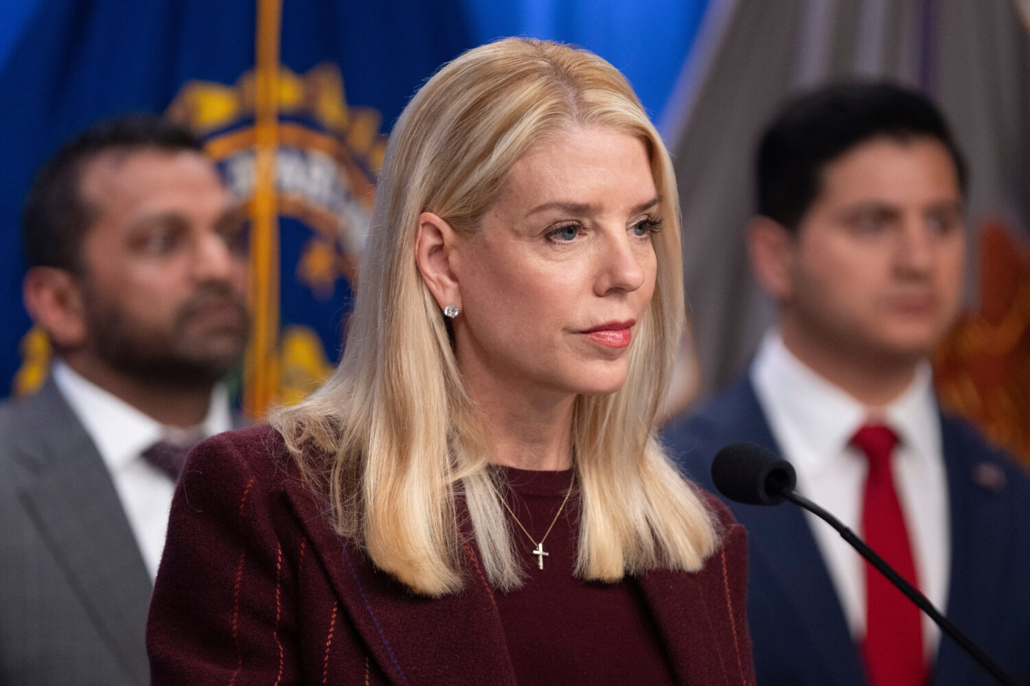 Attorney General Pam Bondi speaks with reporters as FBI Director Kash Patel, left, and Bill Essayli...