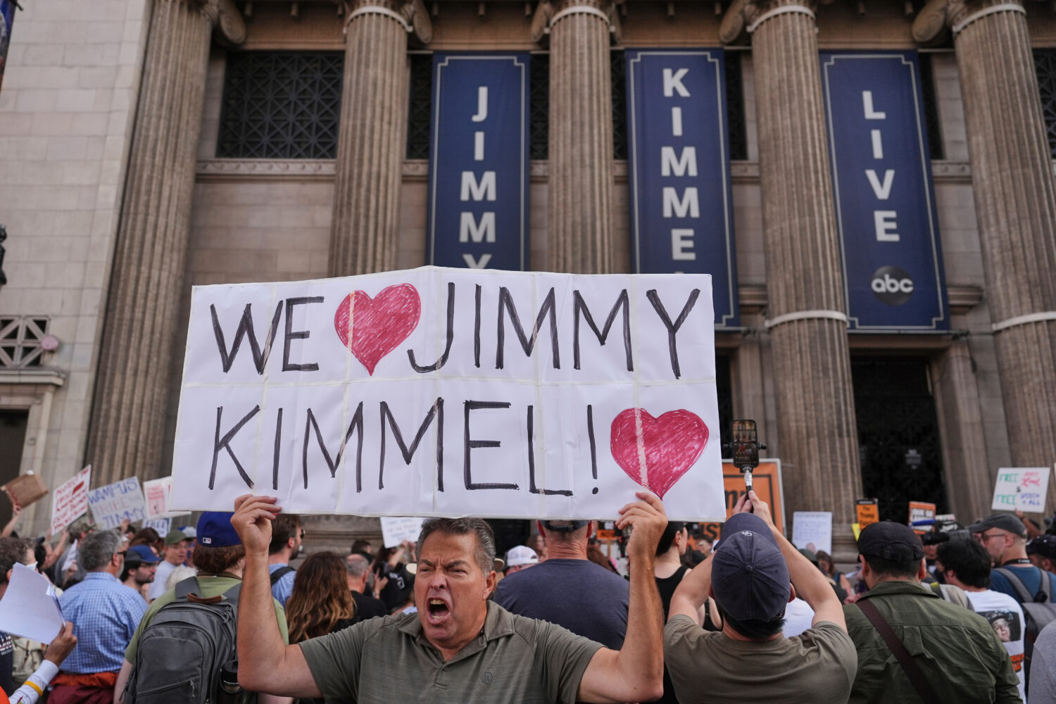 FILE - Oscar Villanueva holds a sign outside El Capitan Entertainment Centre, where the late-night ...