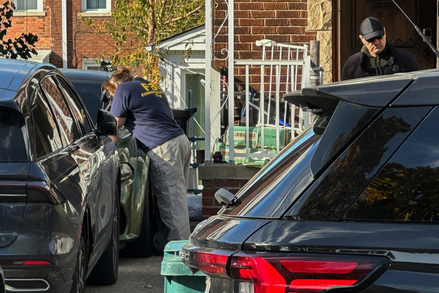 FBI agents gather outside a home in a Dearborn, Mich., neighborhood on Friday, Oct. 31, 2025. (AP P...