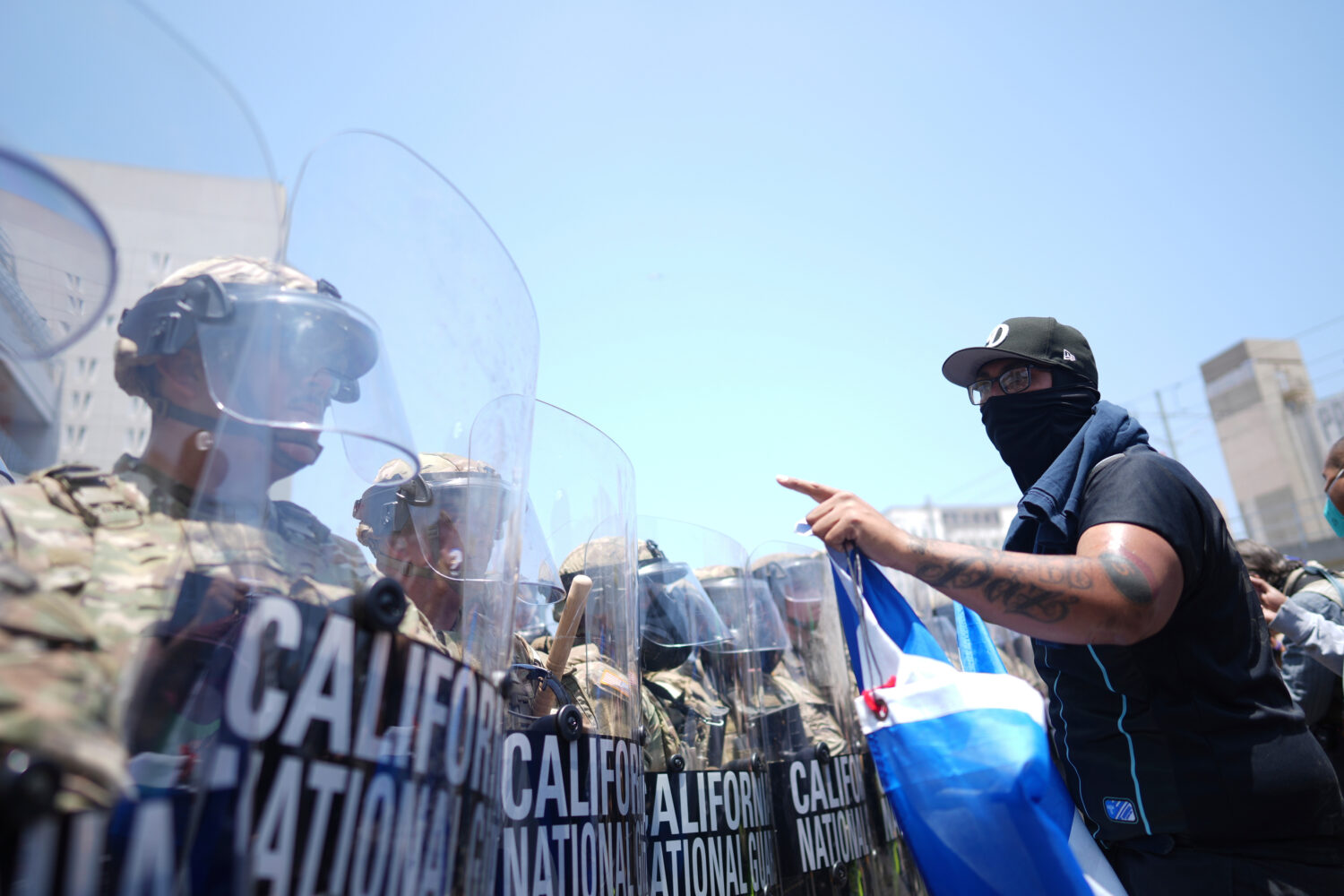 FILE - A protester confronts a line of U.S. National Guard in the metropolitan detention center of ...