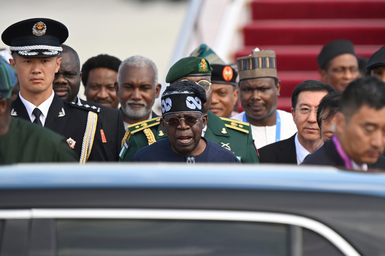 FILE - Nigerian President Bola Ahmed Tinubu, center, arrives at Beijing Capital International Airpo...