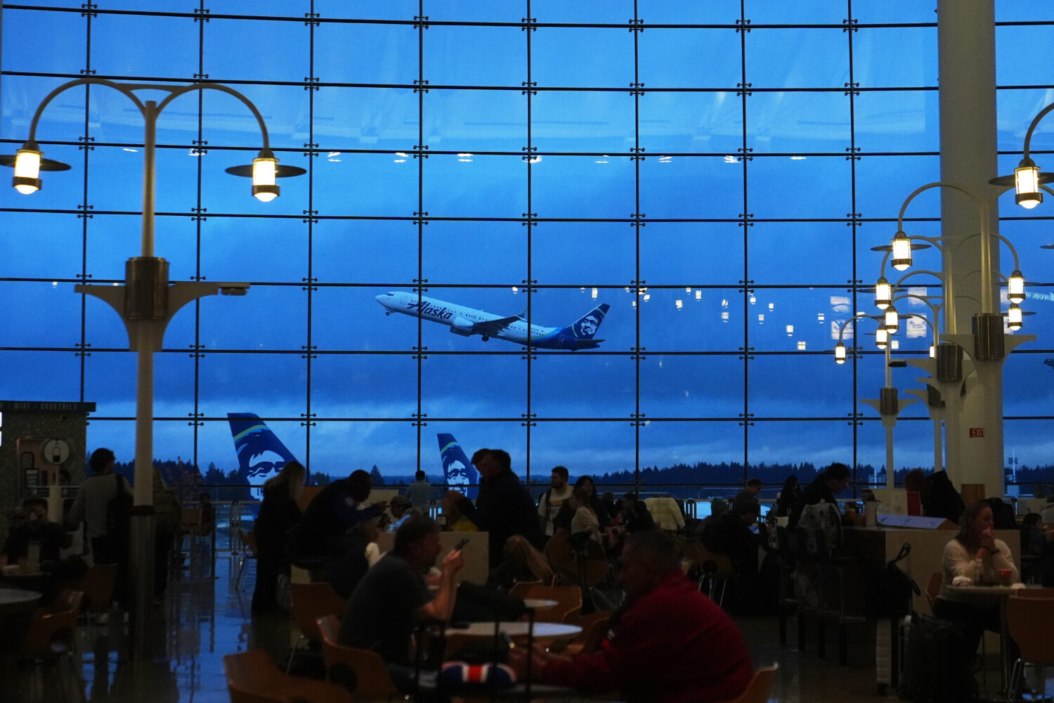 An Alaska Airlines airplane is seen from the central terminal as it takes off at Seattle-Tacoma Int...