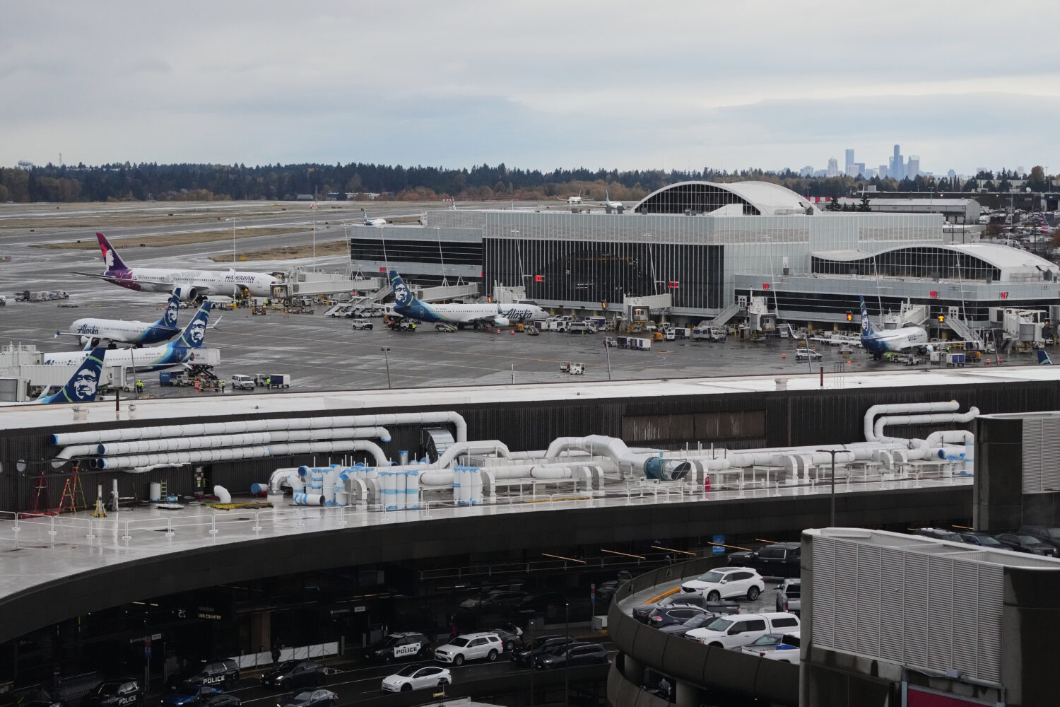 FILE - Hawaiian and Alaska Airlines airplanes are seen parked at gates at Seattle-Tacoma Internatio...