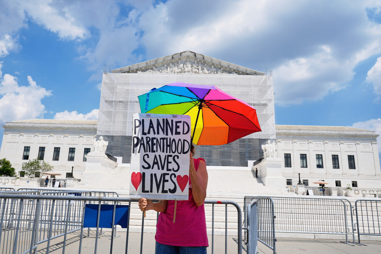 FILE - A protester stands outside of the Supreme Court, June 26, 2025, in Washington. (AP Photo/Mar...