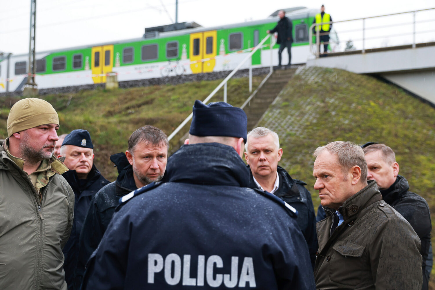 Prime Minister Donald Tusk, second right, visits site of the rail line Mika, that was damaged by sa...