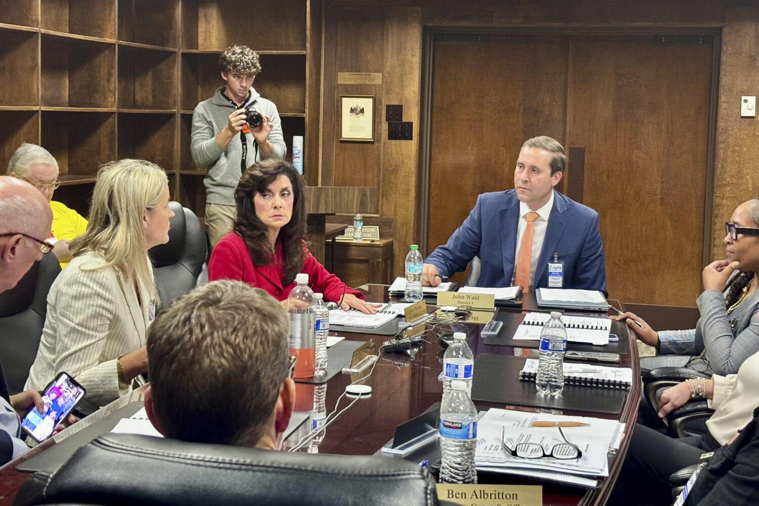John Wahl, chairman of the Alabama Public Library Service Board of Directors, center right, listens...