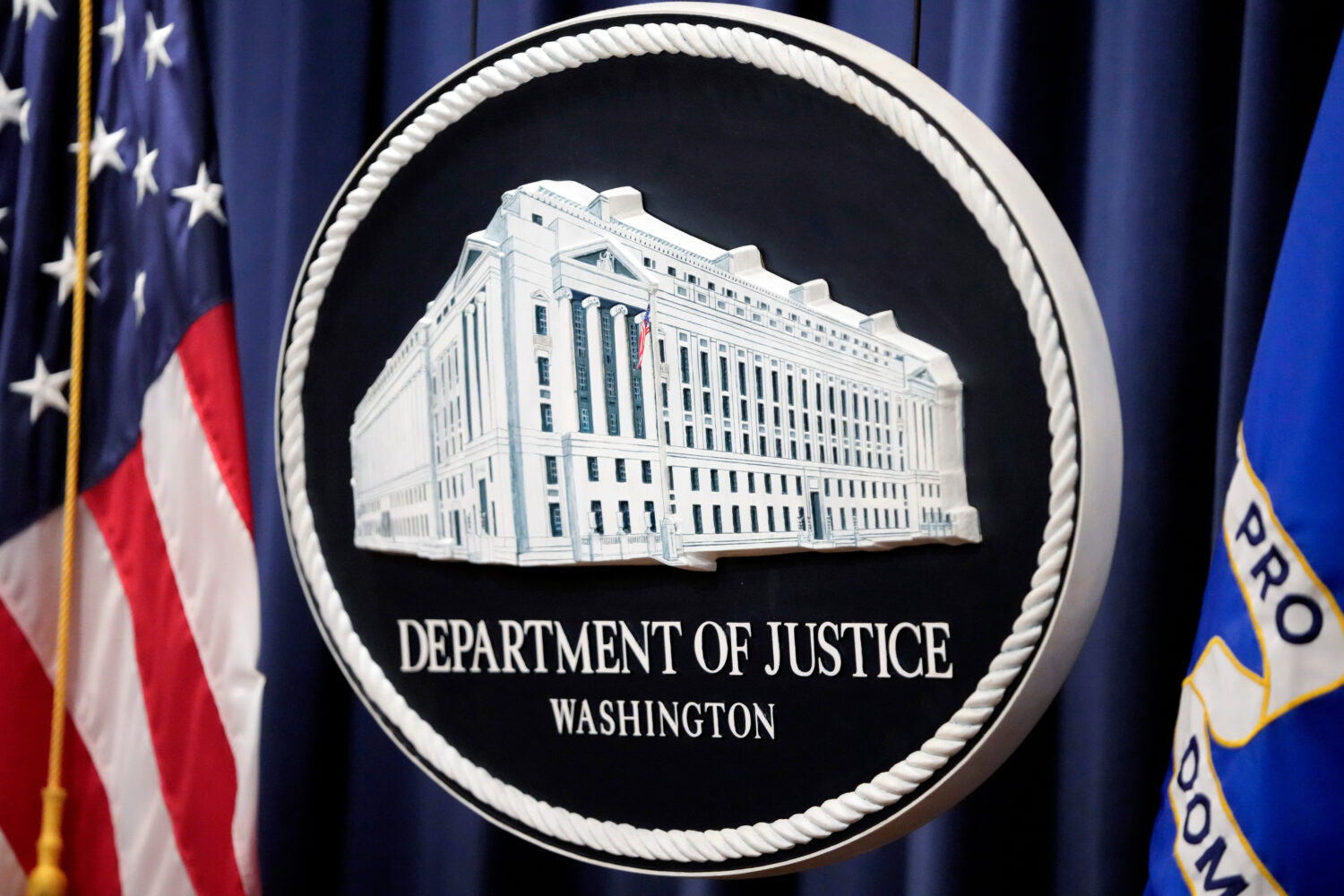 FILE - The logo for the Justice Department is seen before a news conference at the Department of Ju...