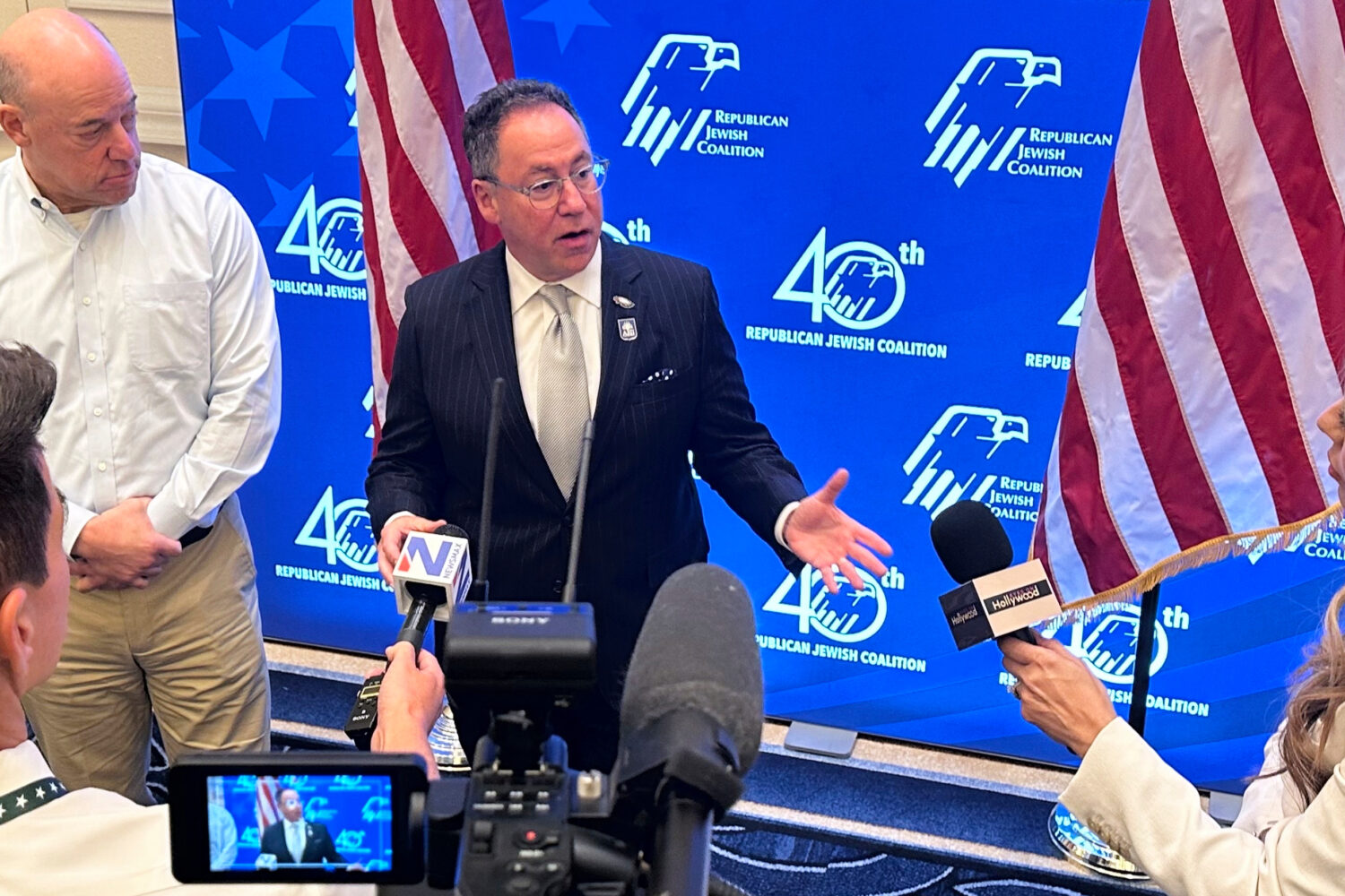 Republican Jewish Coalition CEO Matt Brooks, center, alongside Ari Fleischer, an RJC board member a...