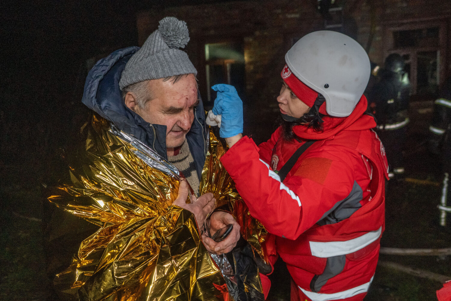 A paramedic gives first aid to a resident who was injured in a Russian airstrike in Kharkiv, Ukrain...