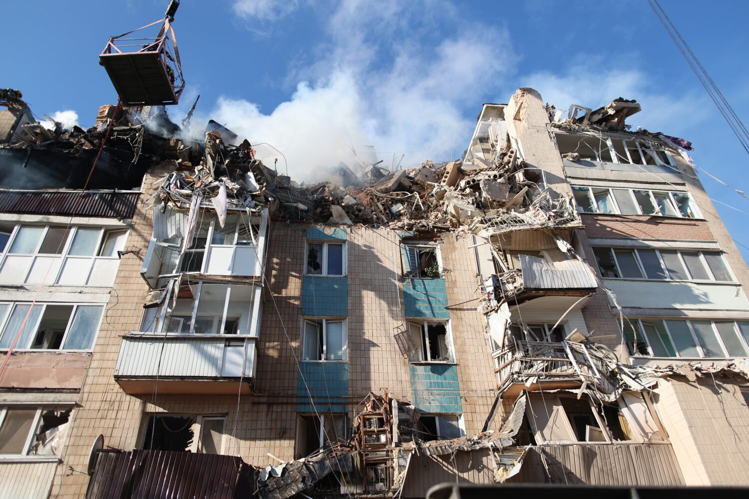 Rescue workers clear the rubble of a residential building which was heavily damaged by a Russian st...