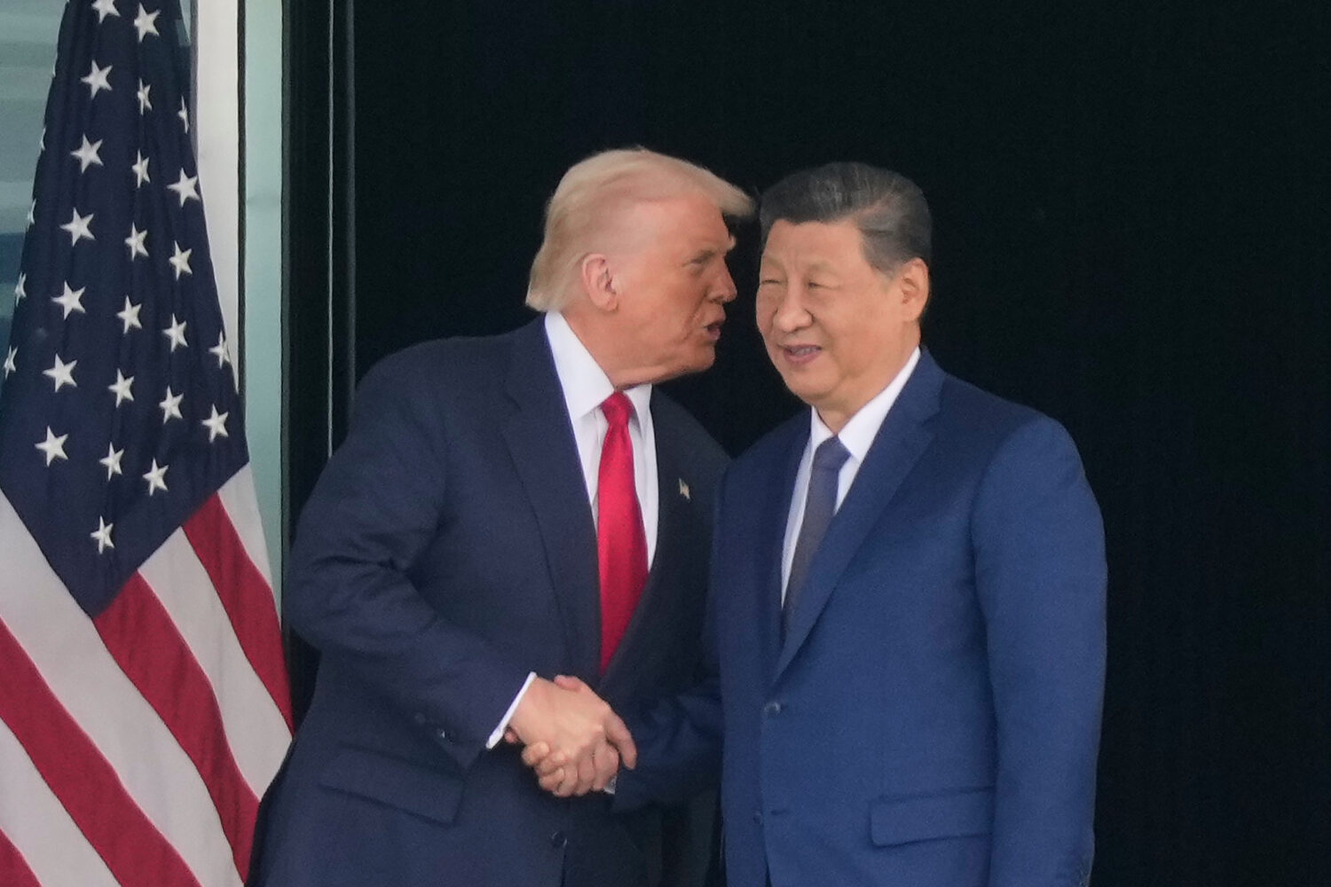 President Donald Trump, left, and Chinese President Xi Jinping, right, shake hands after their U.S....