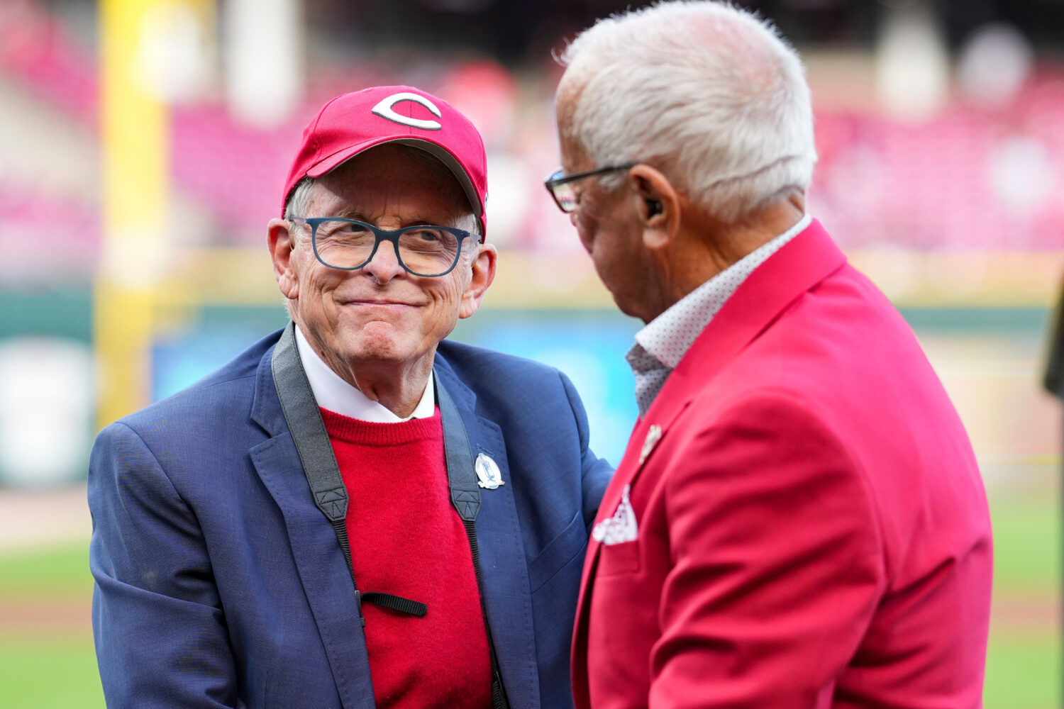 FILE - Hall of Fame broadcaster Marty Brennaman, right, speaks with Ohio Gov. Mike DeWine, left, du...