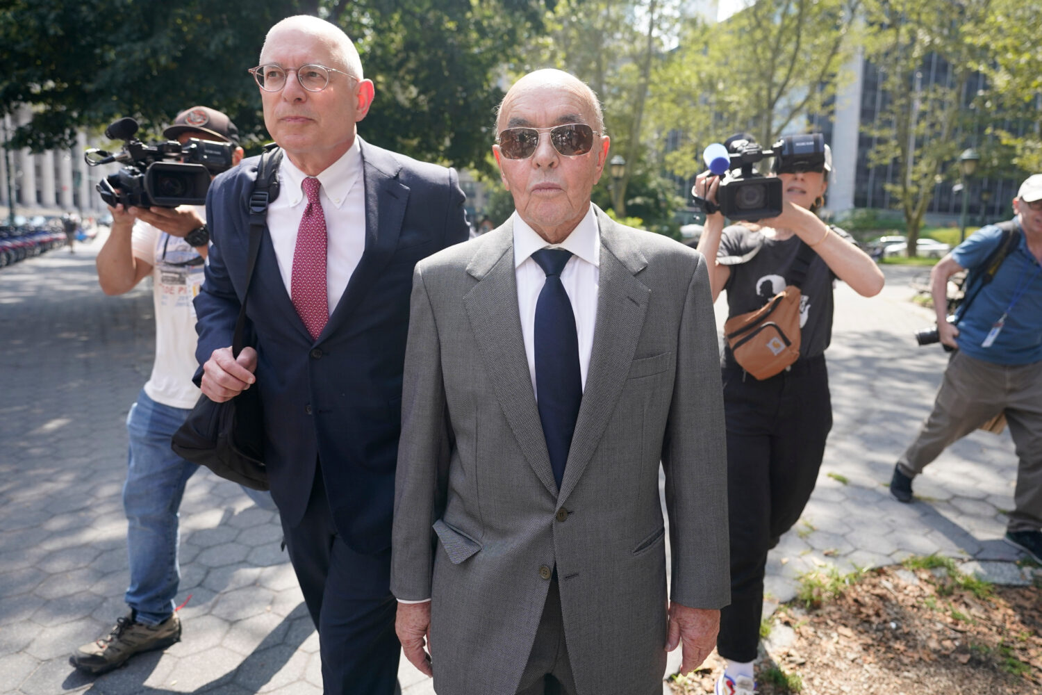 FILE - British billionaire Joe Lewis leaves, center, Manhattan federal court, July 26, 2023, in New...