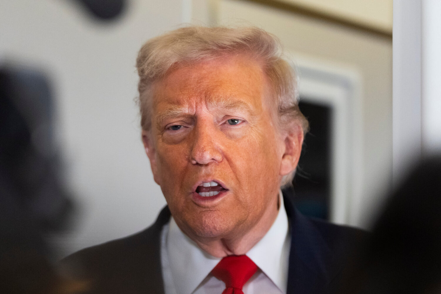 President Donald Trump speaks to the media after boarding Air Force One at Joint Base Andrews, Md.,...