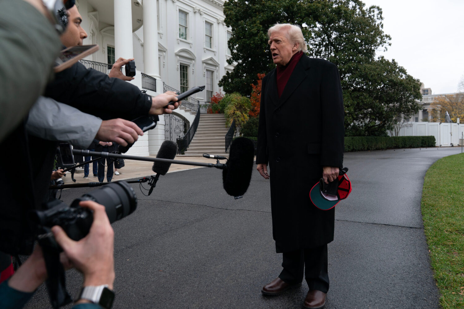 President Donald Trump talks to reporters as he departs from the South Lawn of the White House, Sat...