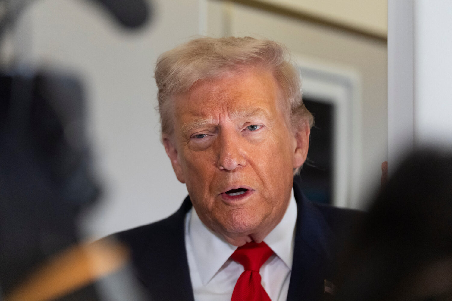 President Donald Trump speaks to the media after boarding Air Force One at Joint Base Andrews, Md.,...