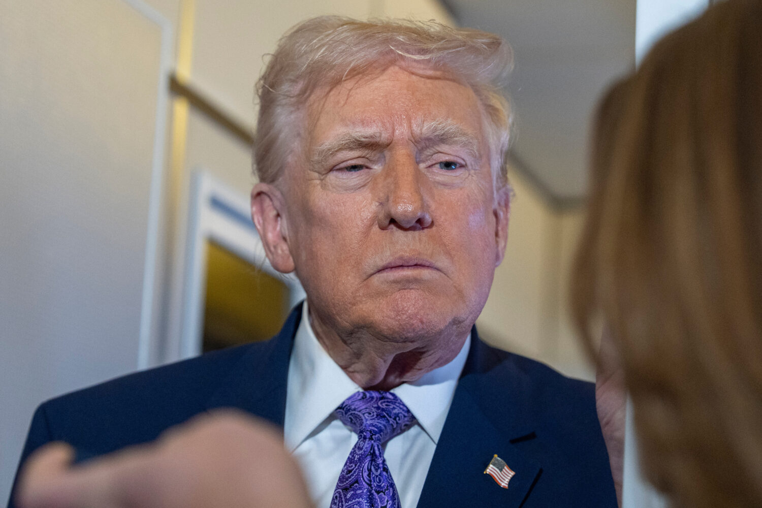President Donald Trump speaks with reporters while in flight on Air Force One from his Mar-a-Lago e...