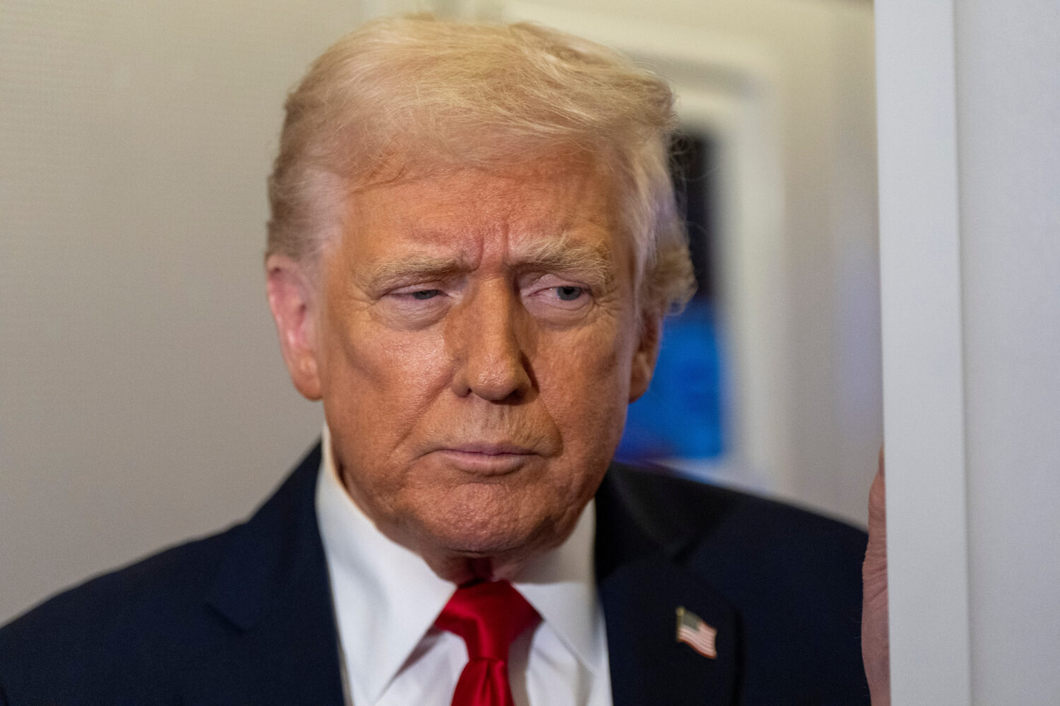 President Donald Trump speaks with reporters while in flight on Air Force One from Joint Base Andre...