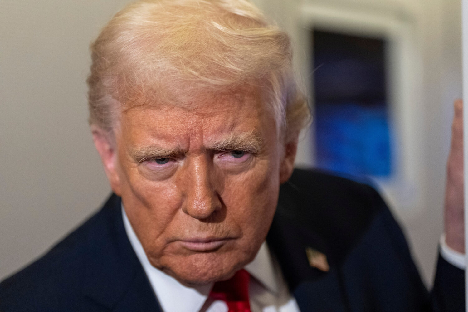 President Donald Trump leans in to hear a question as he speaks with reporters while in flight on A...