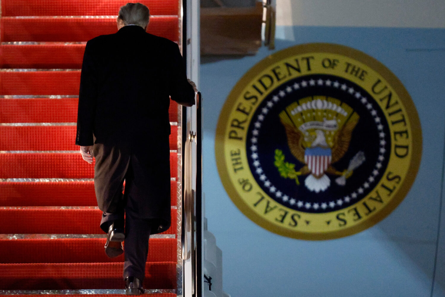 President Donald Trump walks up the stairs of Air Force One as he boards upon his arrival at Joint ...