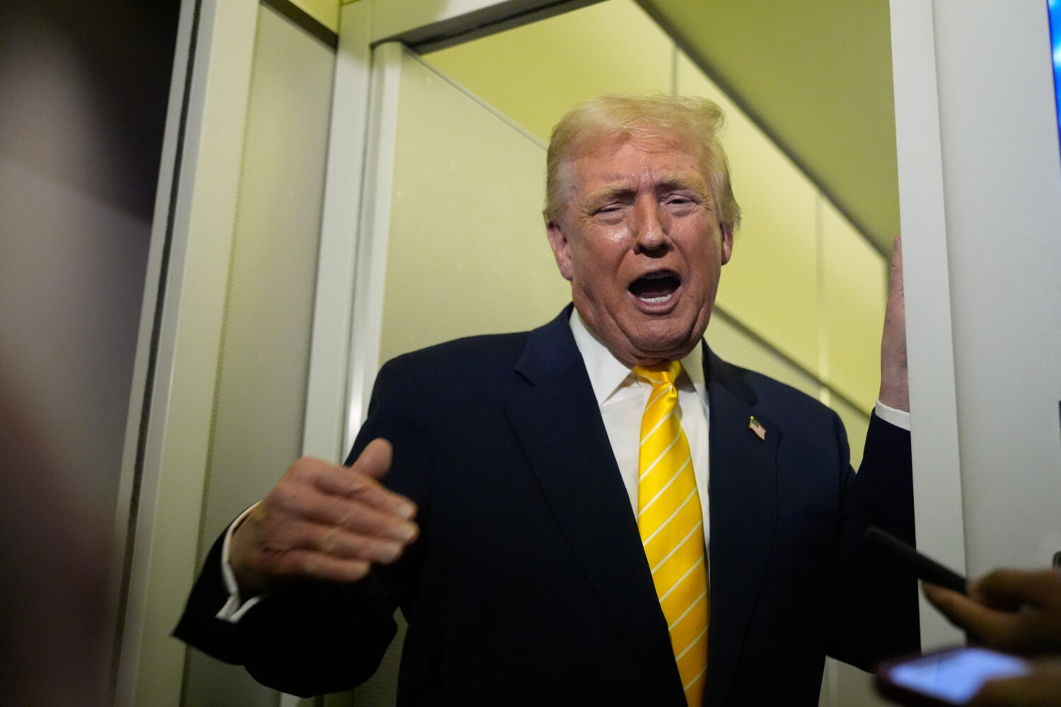 President Donald Trump speaks to reporters on Air Force One on his way to his Mar-a-Lago estate in ...